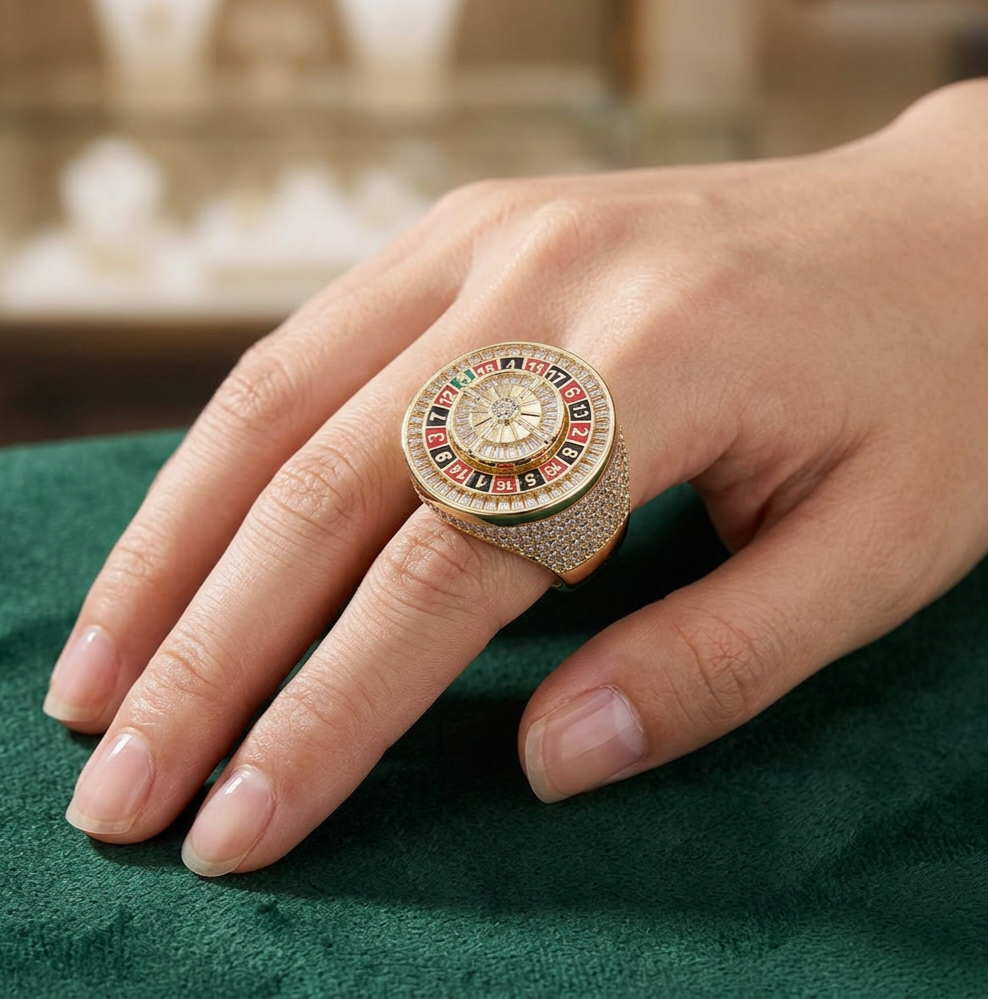 Gold roulette diamond ring worn on hand with green felt background