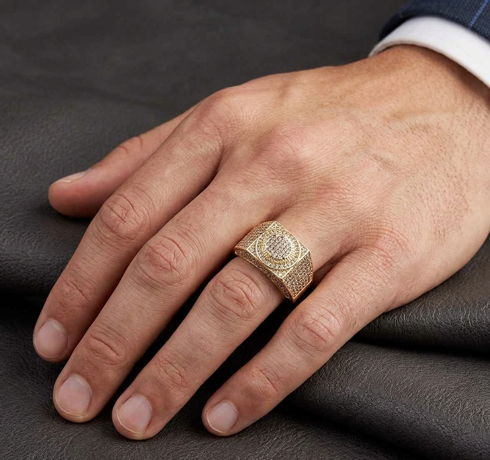 Gold iced out diamond ring worn on hand with dark shirt
