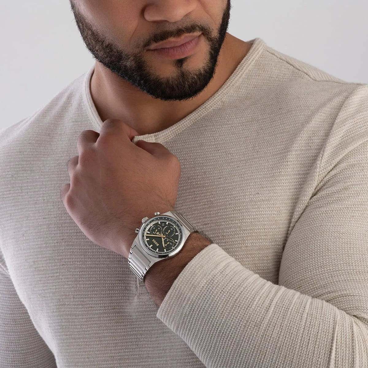 BOSS green chronograph watch worn on wrist with dark green dial visible