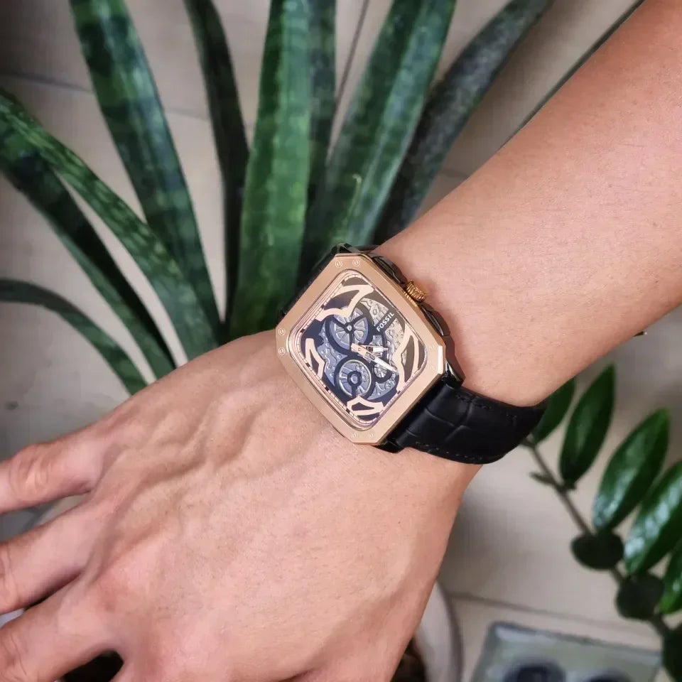Fossil Inscription automatic watch worn on wrist with skeleton dial visible