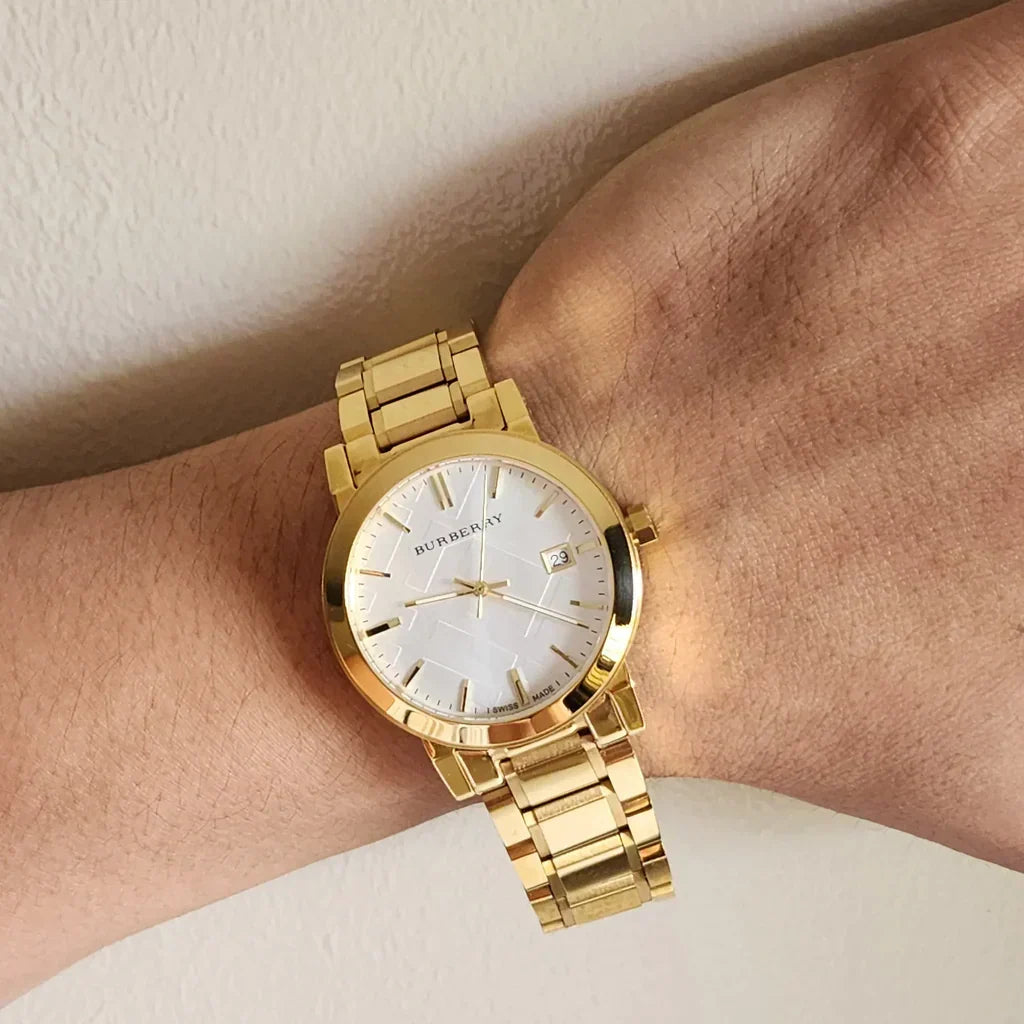 Burberry BU9003 white dial watch on wrist showing yellow gold-plated case and bracelet