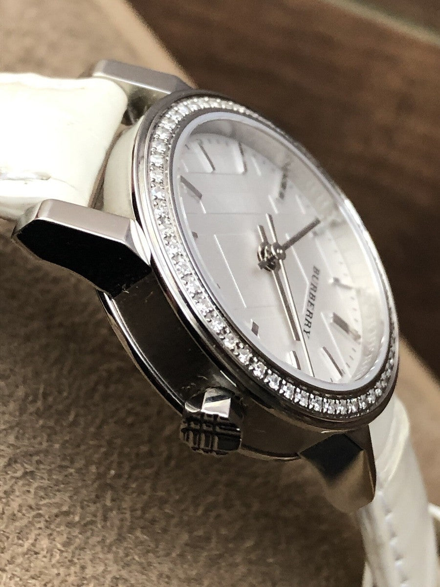 Burberry The City watch on wrist angled view showing white leather strap and diamond bezel