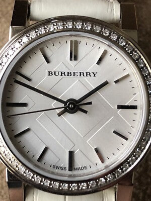 Burberry The City white dial close-up with diamond bezel and Burberry branding