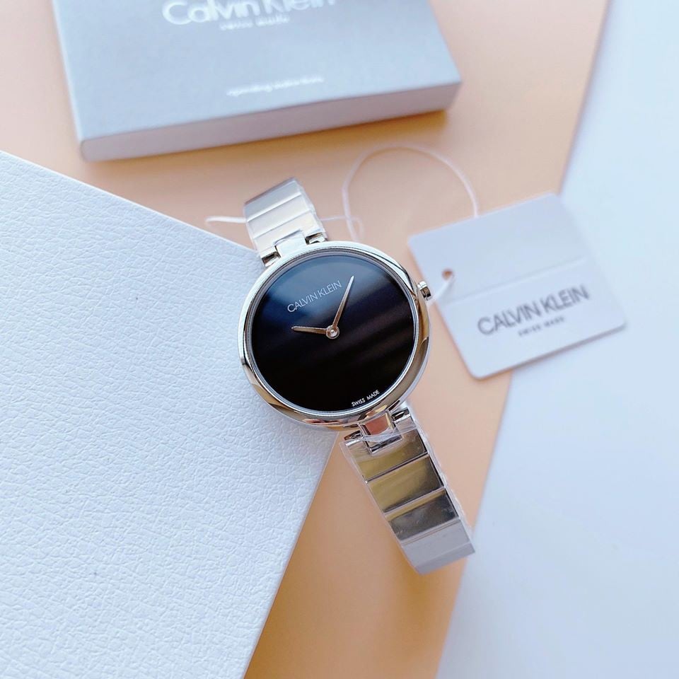 Calvin Klein Authentic black dial ladies watch worn on wrist with branded box and materials