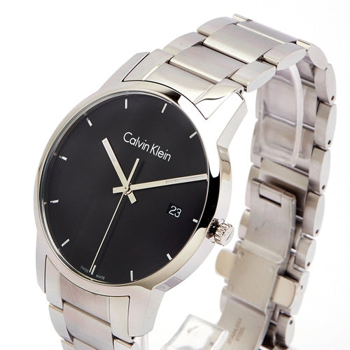 Calvin Klein City men's watch worn on wrist, black dial with silver bracelet