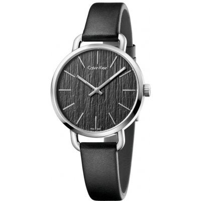 Calvin Klein Even watch at angle displaying black textured dial and leather strap