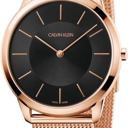 Close-up of black dial with rose gold hour markers and Calvin Klein branding