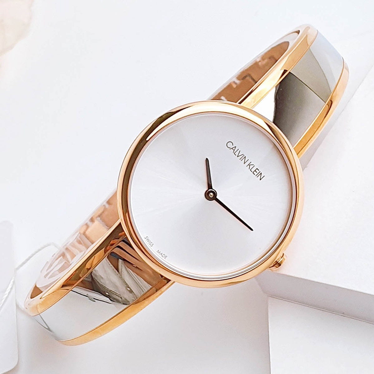 Calvin Klein K4E2N61Y watch worn on wrist showing rose gold case and white strap