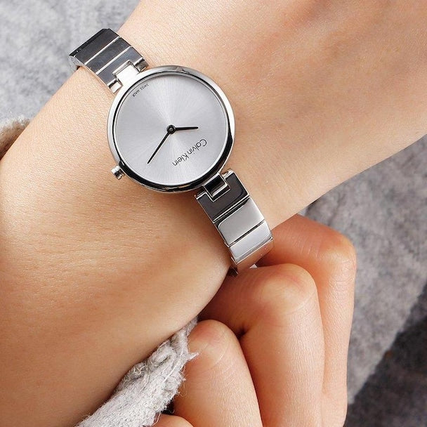 Calvin Klein K8G23146 women's watch worn on wrist with white dial and silver mesh bracelet