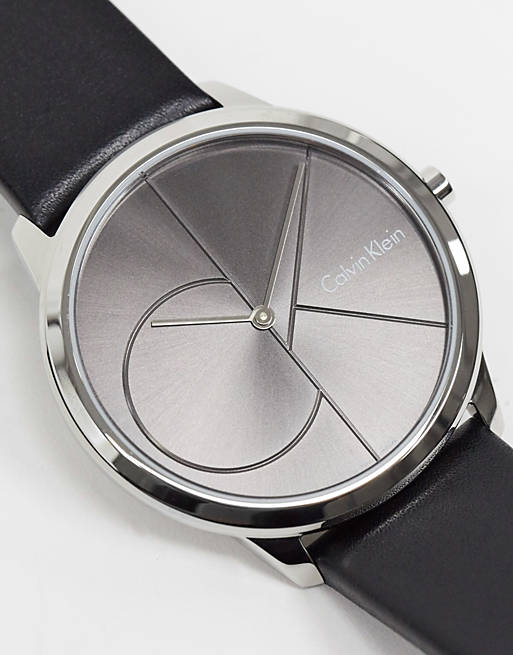 Angled view of grey dial watch with geometric divisions and black strap