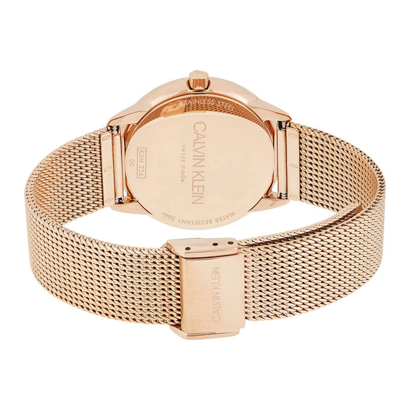 Caseback view of Calvin Klein Minimal watch showing rose gold case and mesh bracelet clasp