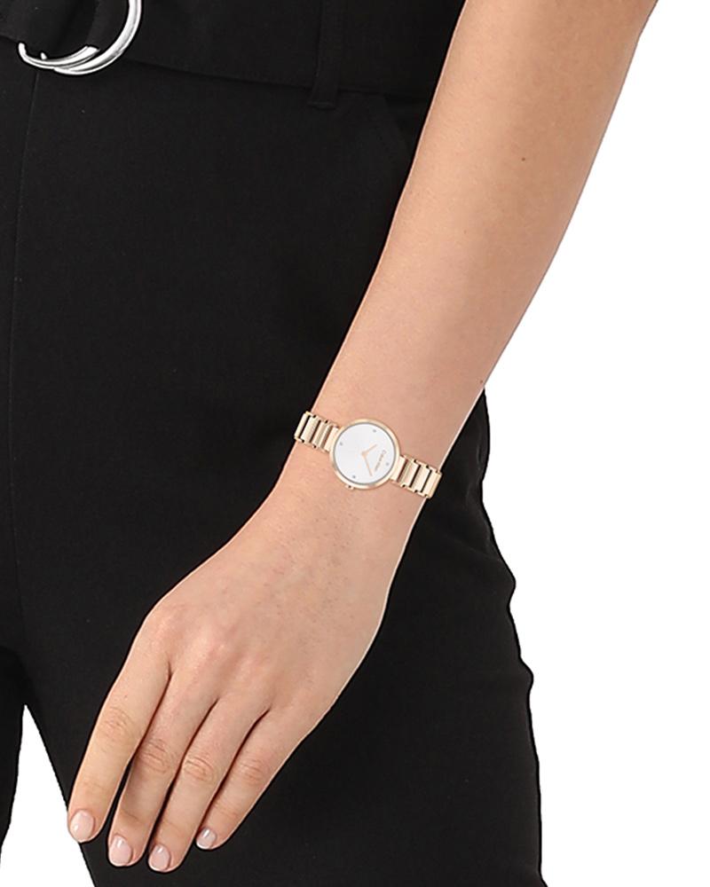 CALVIN KLEIN T Bar white dial gold watch worn on wrist