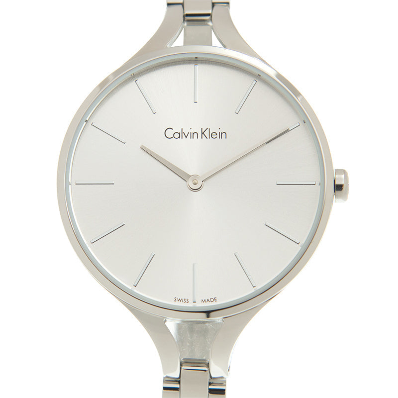 Close-up of Calvin Klein Rise dial with minimalist hour markers and hands