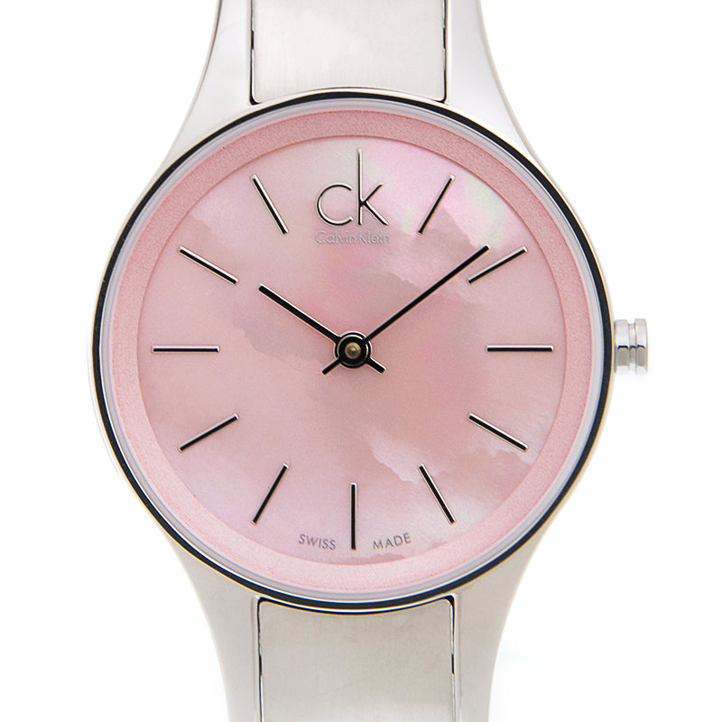 Detailed view of Calvin Klein Simplicity K432314E pink dial with CK logo and Swiss Made marking