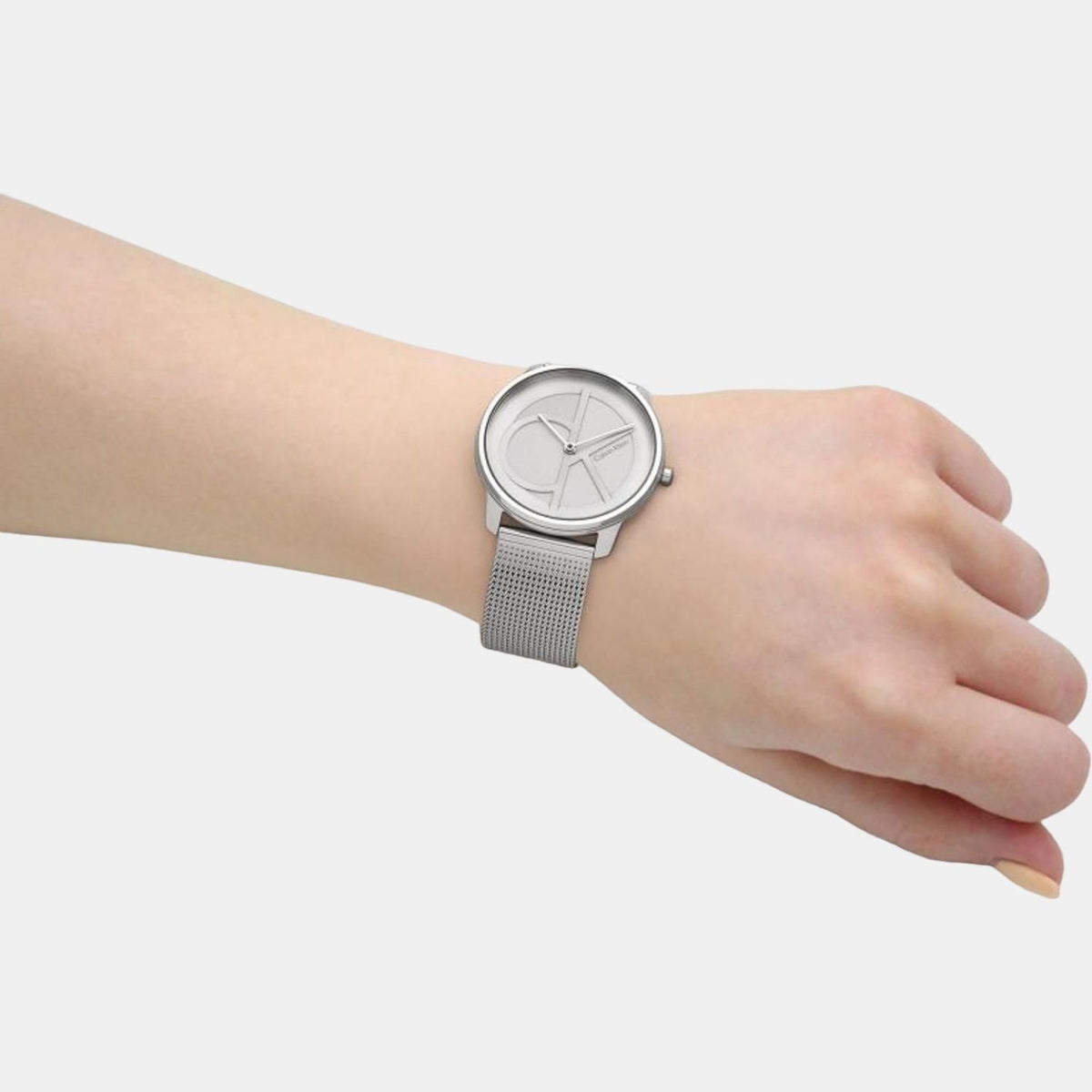 Calvin Klein Stately men's watch on wrist showing white dial and mesh band