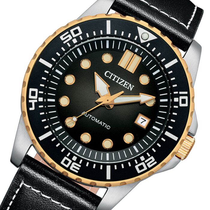 Close-up of Citizen black dial with applied gold indices and white hands with date window