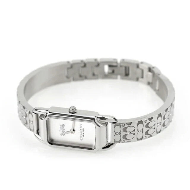 Coach women's watch with Heritage logo dial worn on wrist, stainless steel bracelet