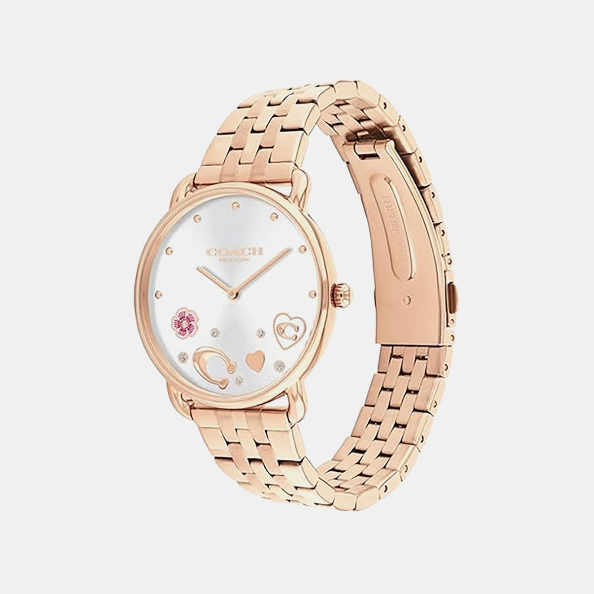Coach rose gold women's watch displayed at angle showing three-link steel bracelet and dial details with heart motif
