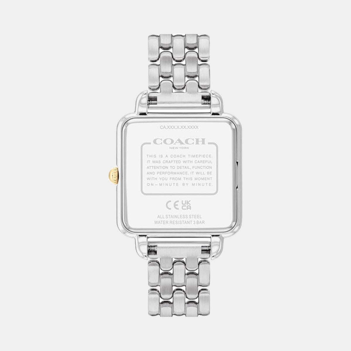 Coach watch caseback showing stainless steel case with engraved branding and specifications