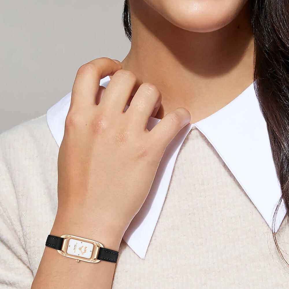 Coach Cadie women's watch worn on wrist with rose gold case and black leather strap
