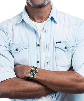 COACH Charter watch worn on wrist with olive green strap and stainless steel case