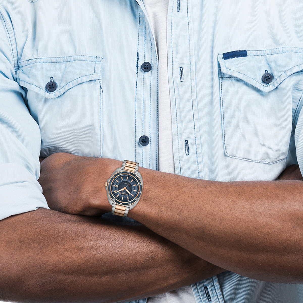 Coach Charter watch worn on wrist with light blue shirt
