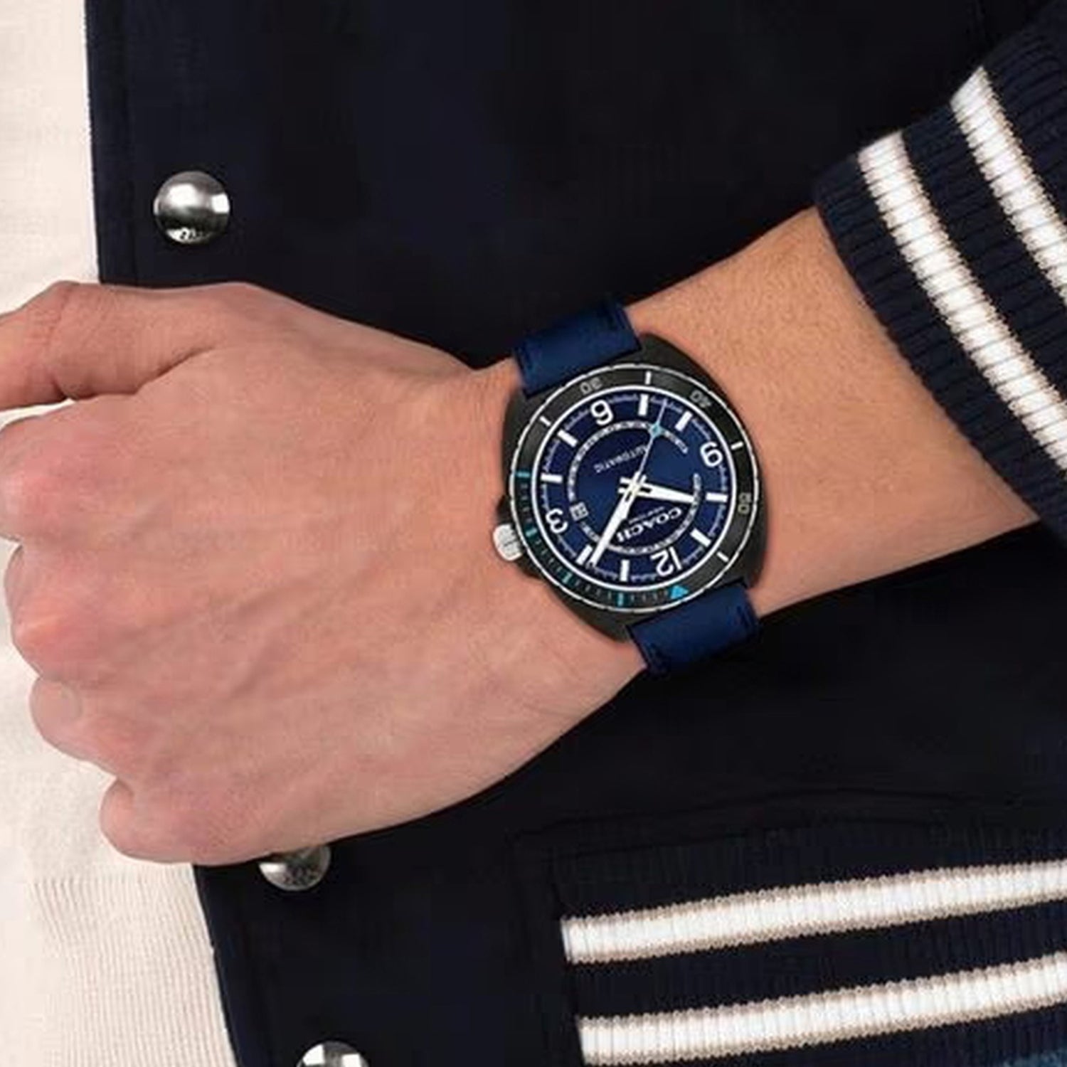 Coach Charter automatic watch on wrist showing blue dial and navy leather strap