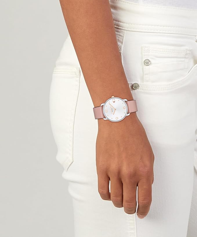 Coach ELLIOT ladies watch on wrist, showing white dial and pink leather strap