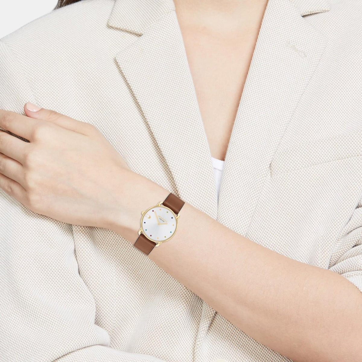 Coach Elliot watch on wrist with gold case and brown leather strap