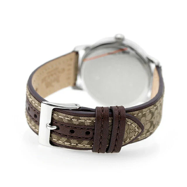 Coach Grand watch strap detail showing khaki signature fabric with brown leather trim and buckle
