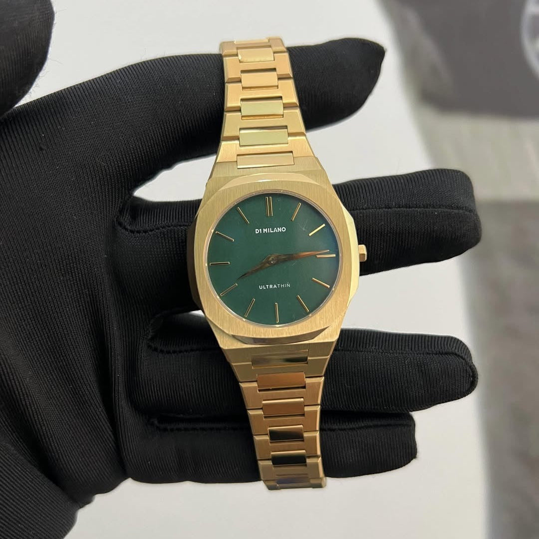D1 Milano UTBL18 gold watch with green dial held in hands