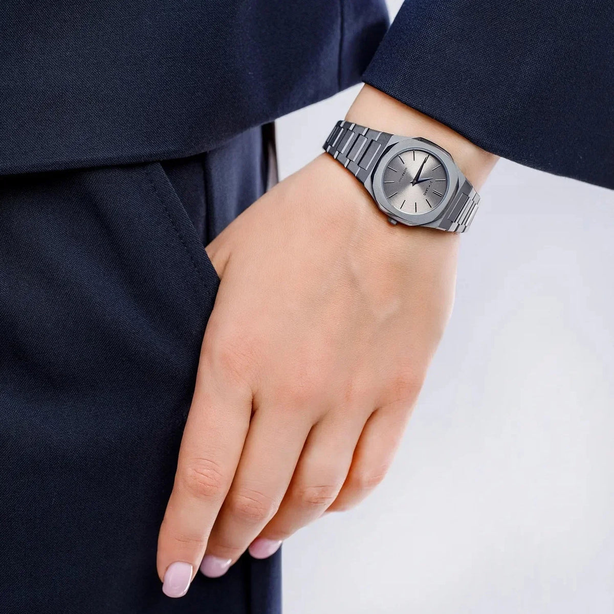 D1 Milano Ultra Thin Ultimate Grey 30mm watch worn on wrist with navy suit