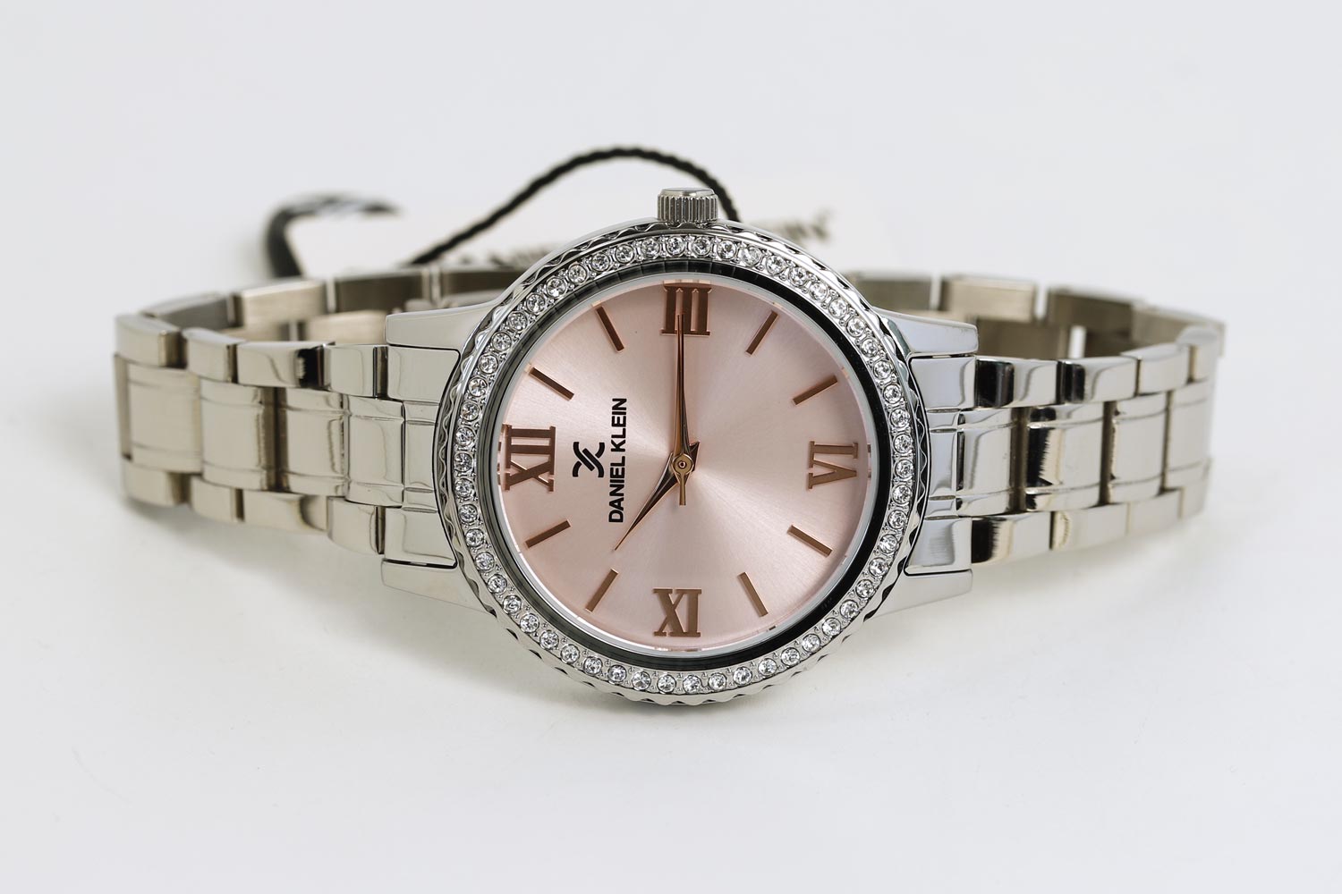 Overhead view of Daniel Klein watch with pink face and silver link bracelet