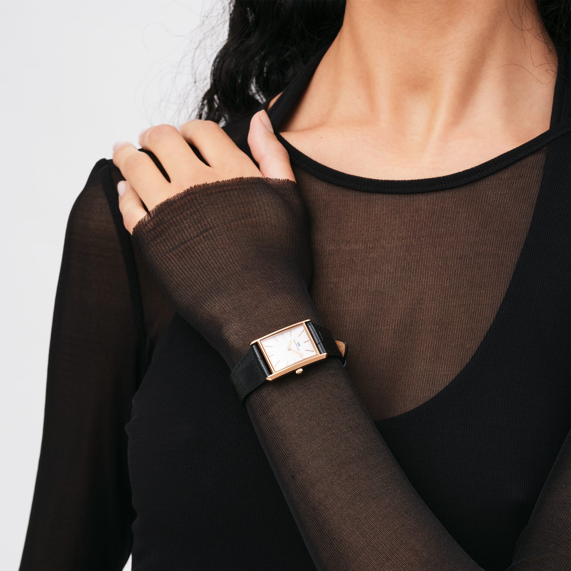 Daniel Wellington Bound rose gold watch on wrist with black crocodile strap