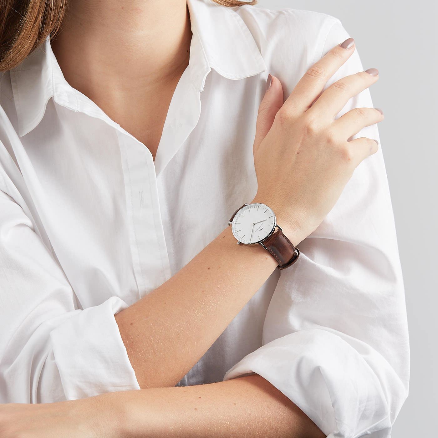 Daniel Wellington Classic Bristol 36mm worn on wrist with white dial and brown leather band