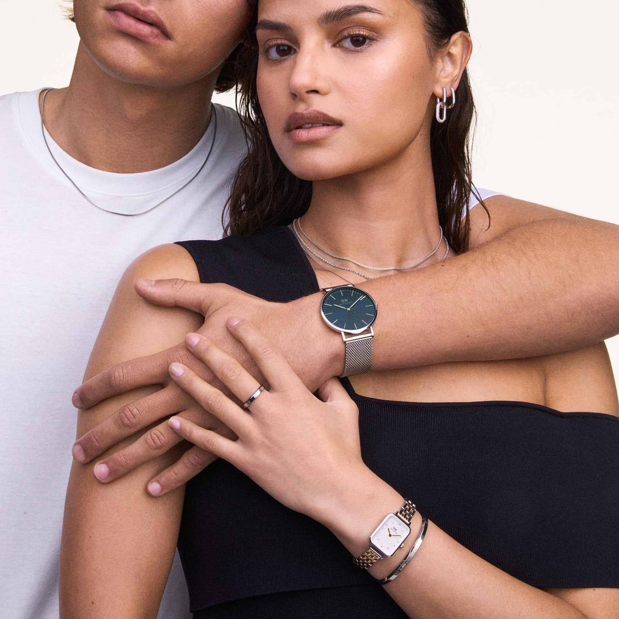Silver cuff bracelet worn on wrist styled with Daniel Wellington watch