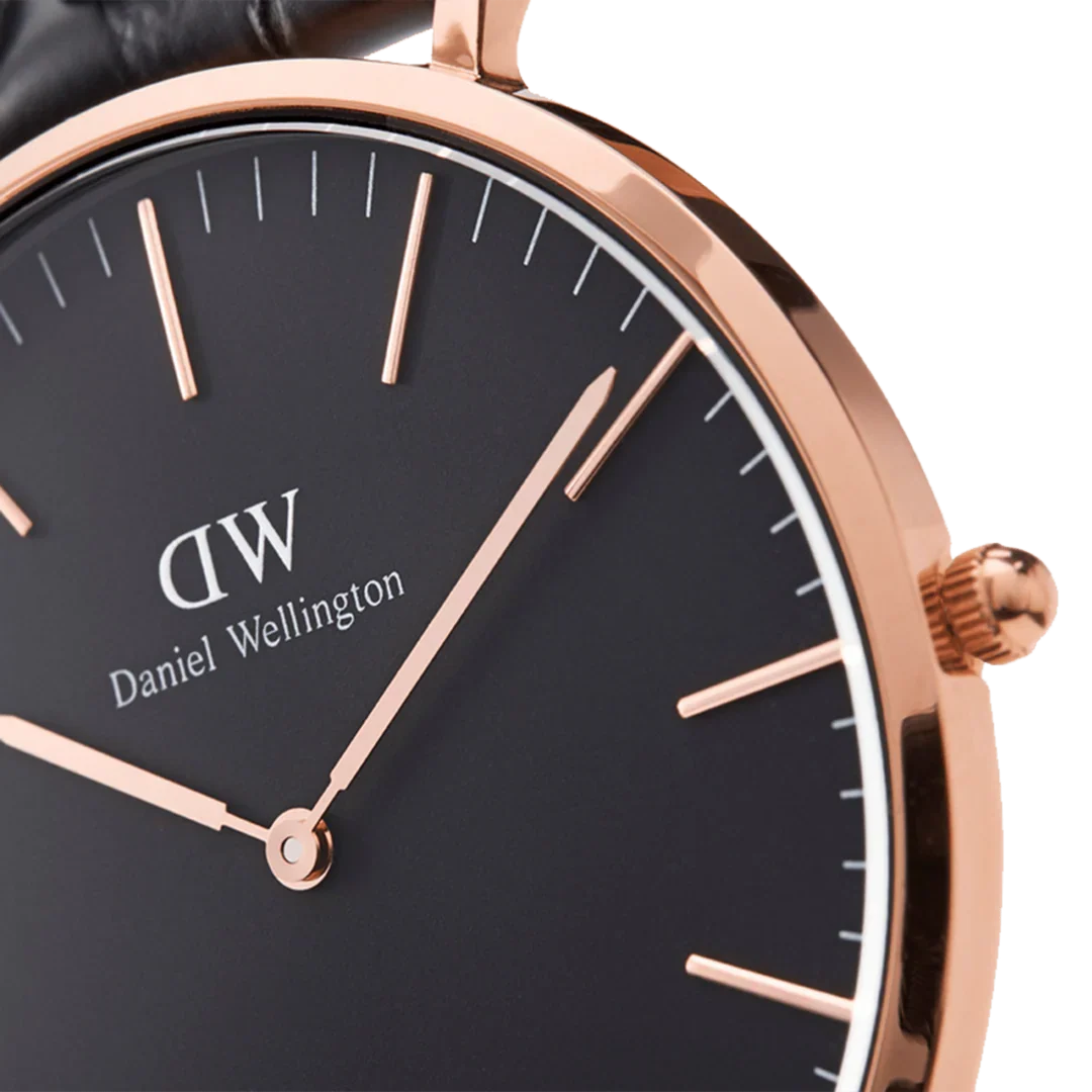 Close-up of Daniel Wellington Classic Durham dial showing rose gold indices and hands on black background