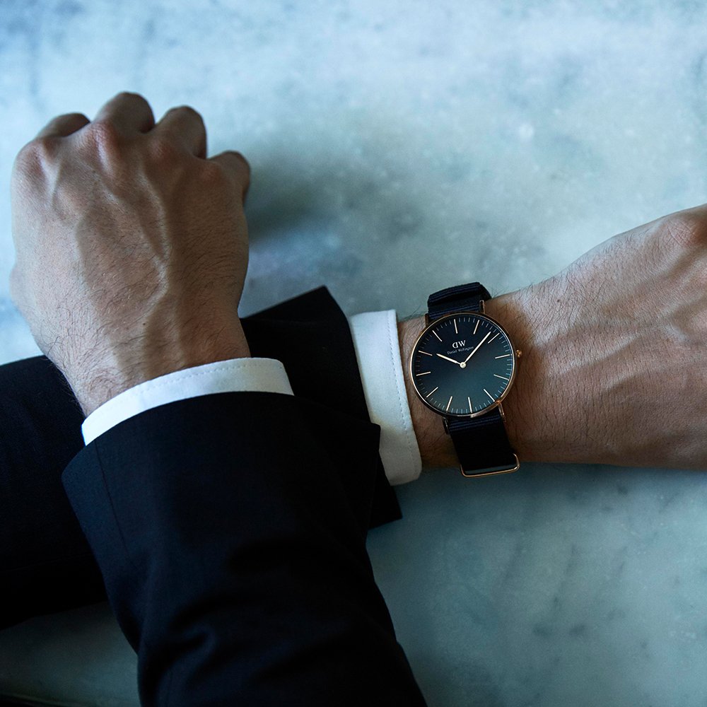 Daniel Wellington Cornwall watch worn on wrist with black fabric strap and rose gold case