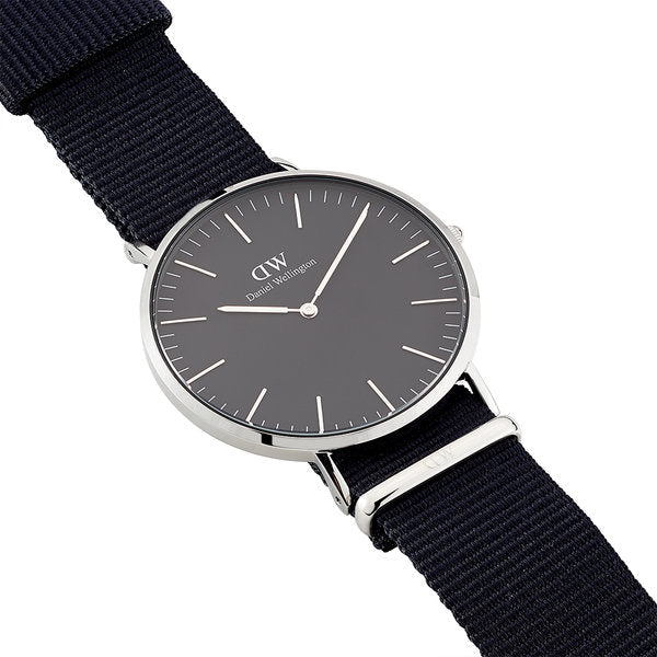 Daniel Wellington Cornwall watch flat lay with navy NATO strap and silver hardware