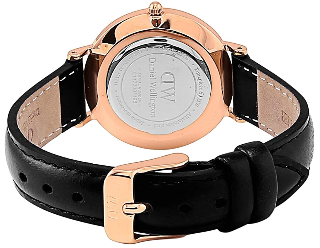 Rose gold case back and black leather strap with stitching detail