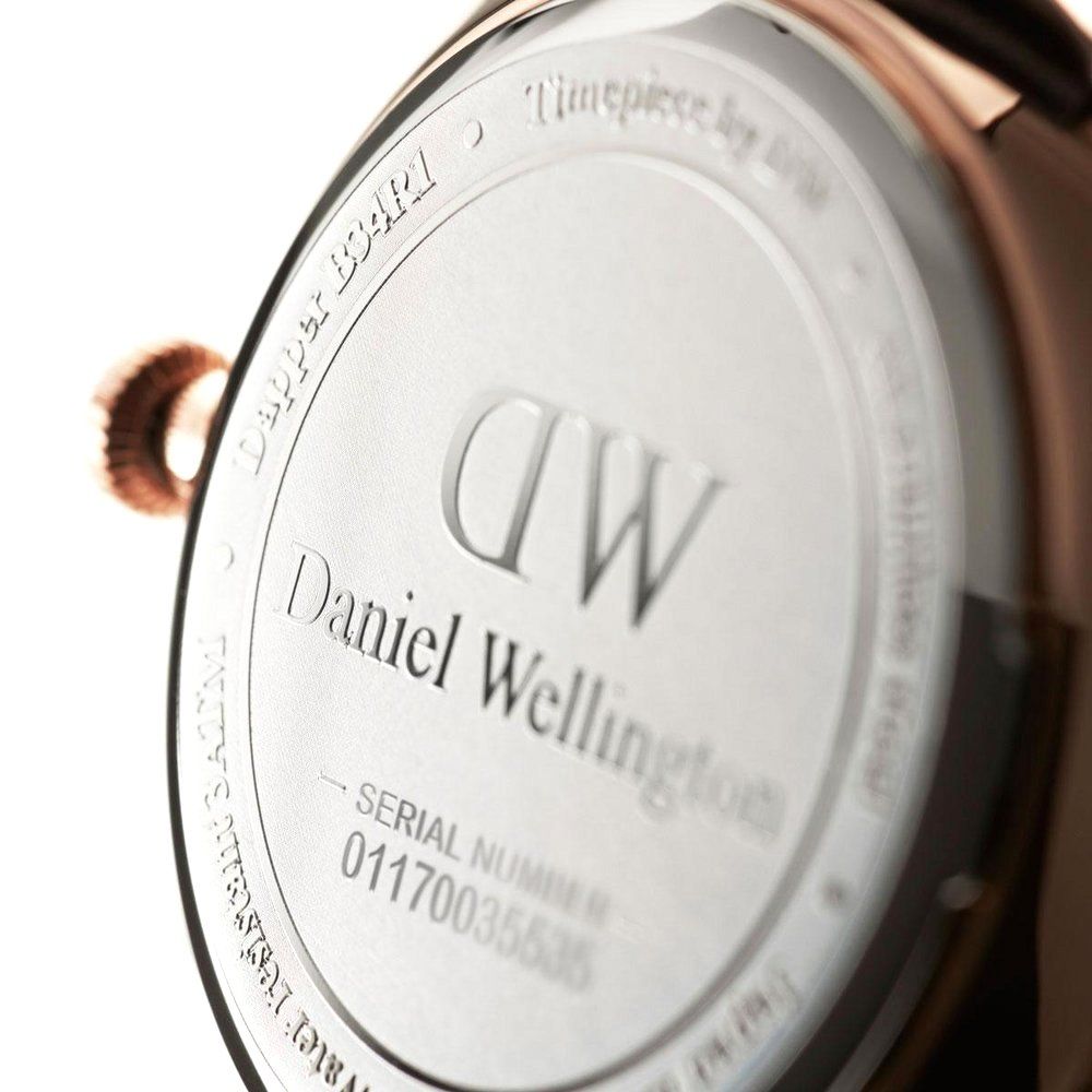 Watch caseback with engraved Daniel Wellington branding and serial number