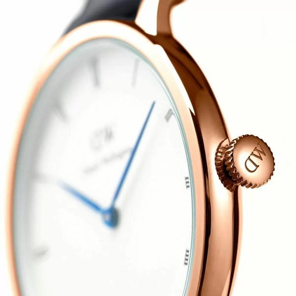 Side view of rose gold case with crown and black nylon strap