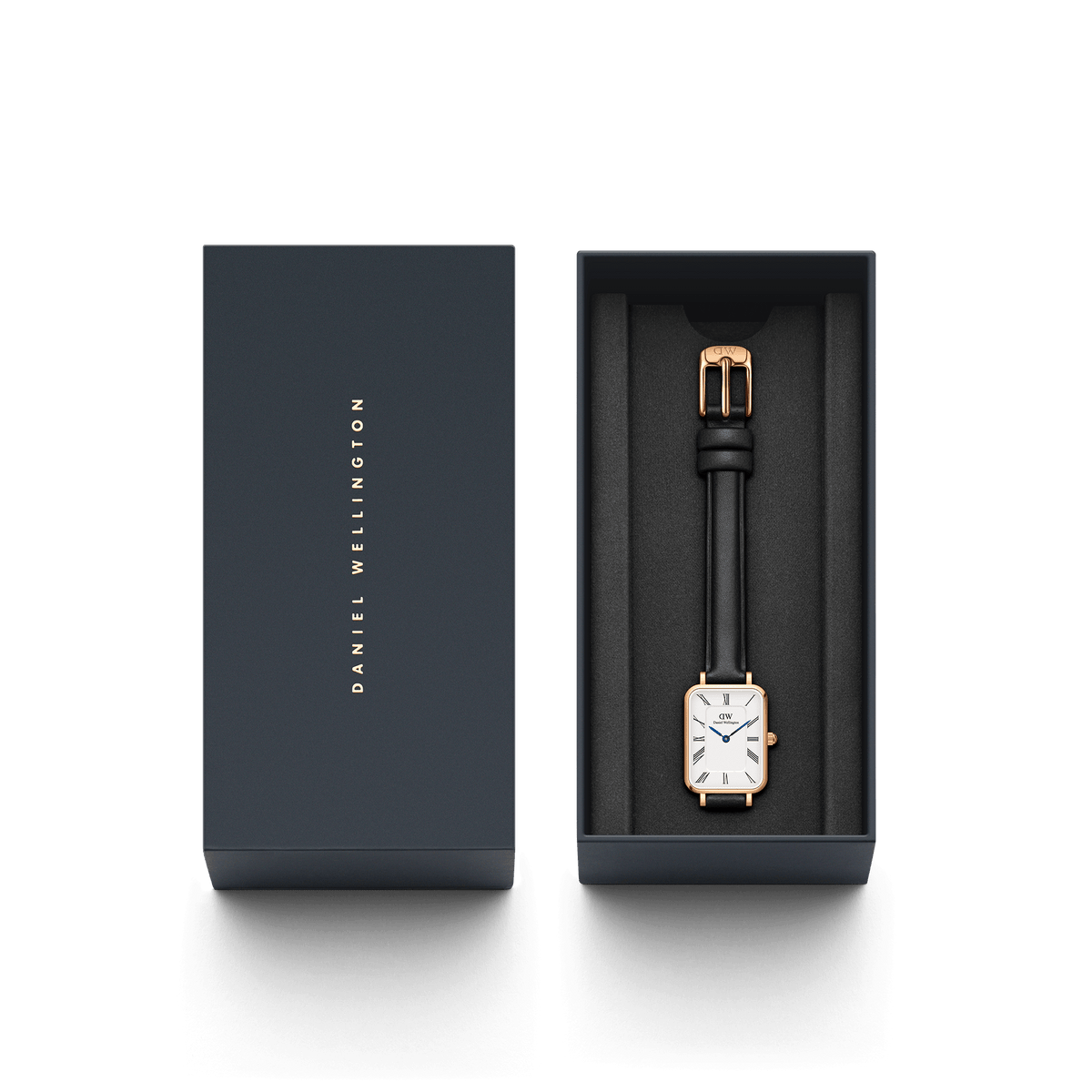 Daniel Wellington watch packaging with dark box and rose gold rectangular watch with black strap