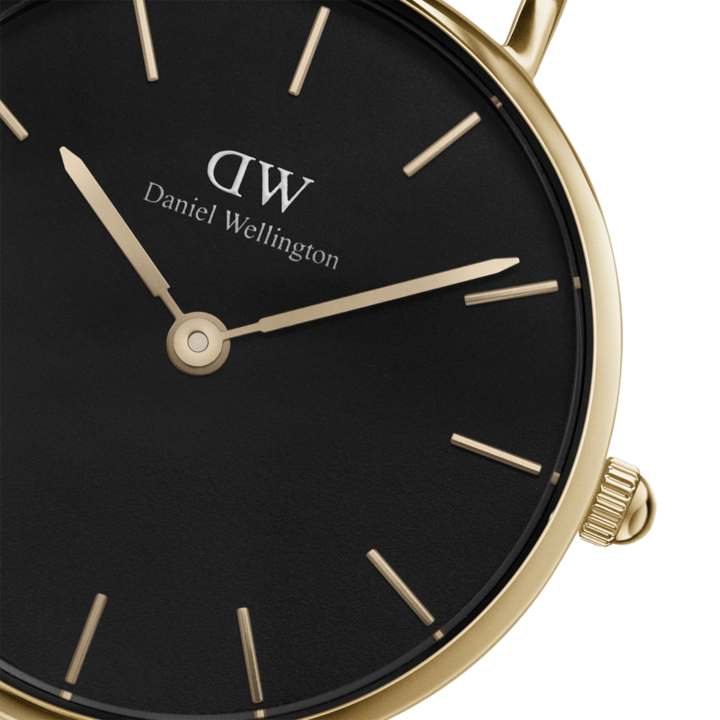 Dial detail showing gold-plated hands and minimalist index markers on black dial