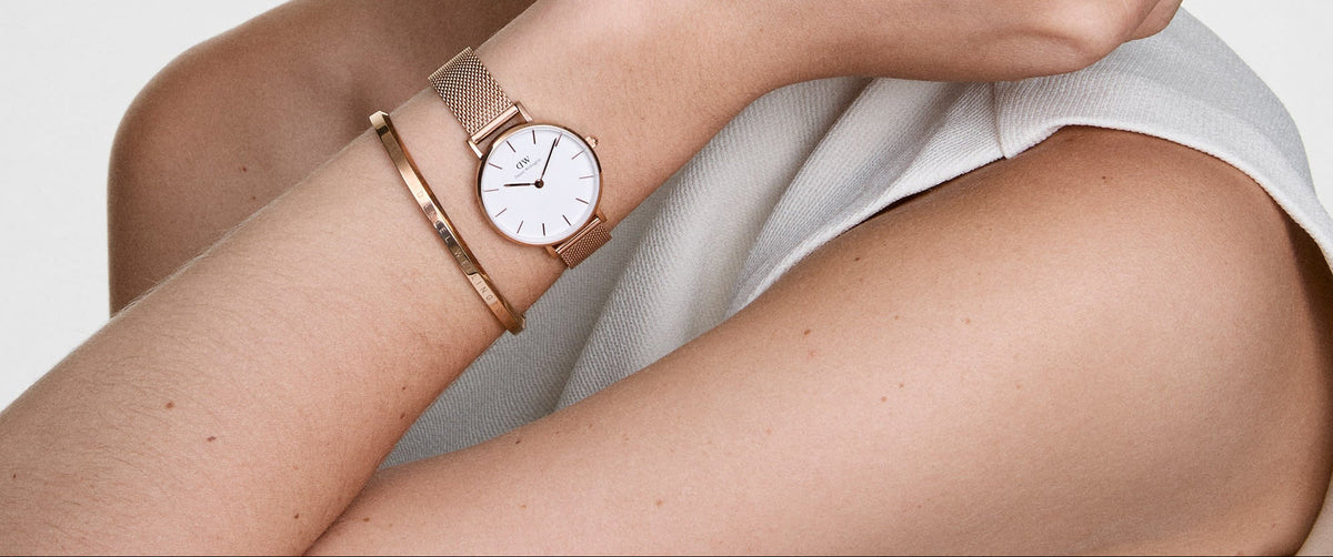 Daniel Wellington Petite Melrose rose gold watch worn on wrist with bracelet