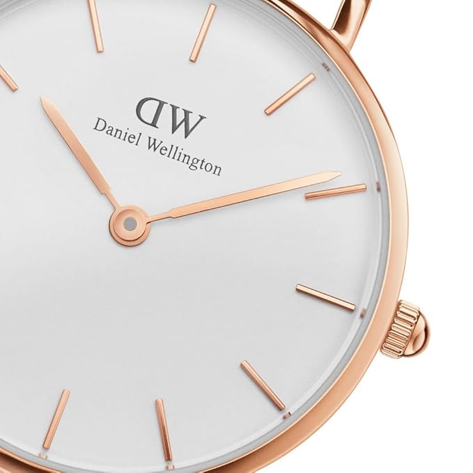 Close-up of white dial with rose gold bar indexes and Daniel Wellington branding