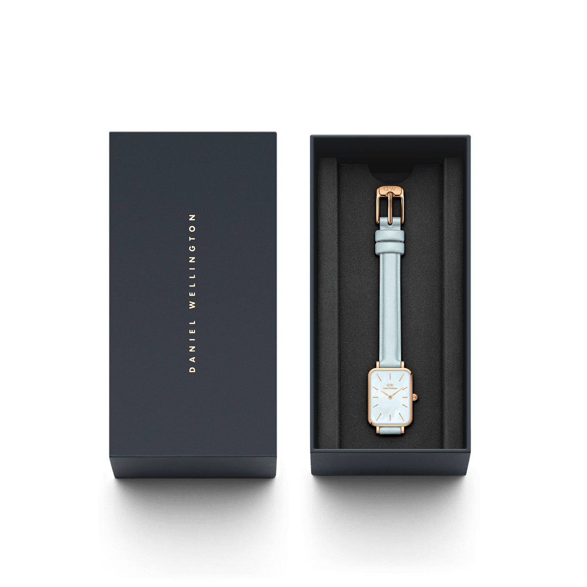 Daniel Wellington Quadro watch displayed in branded dark presentation box with light blue strap
