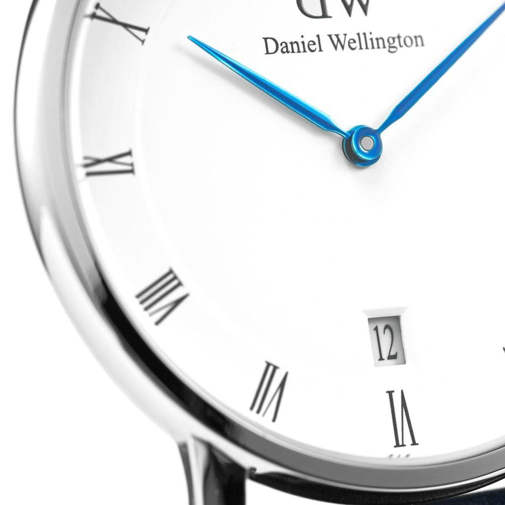 Close-up detail of Dapper Cornwall dial showing roman numerals, DW logo, and blue hands