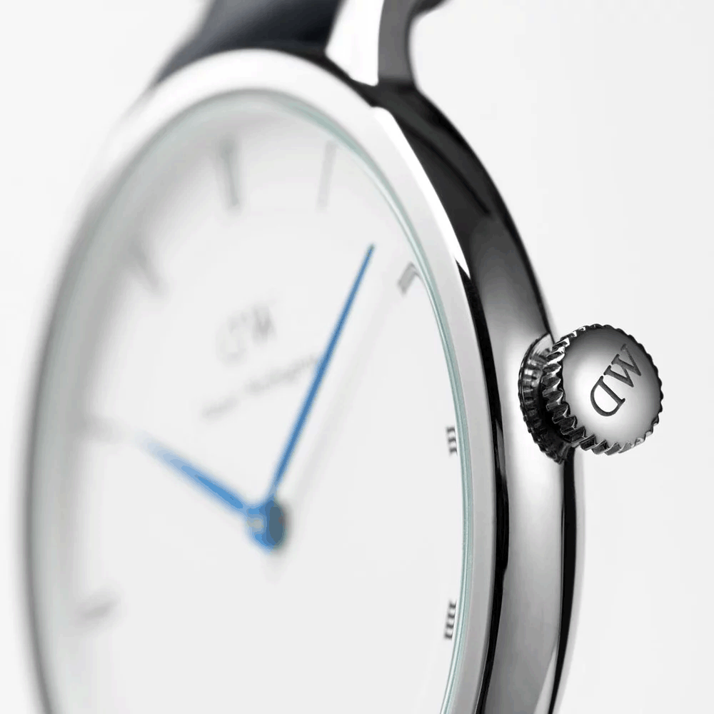 Side profile of Daniel Wellington watch showing silver crown and thin case profile
