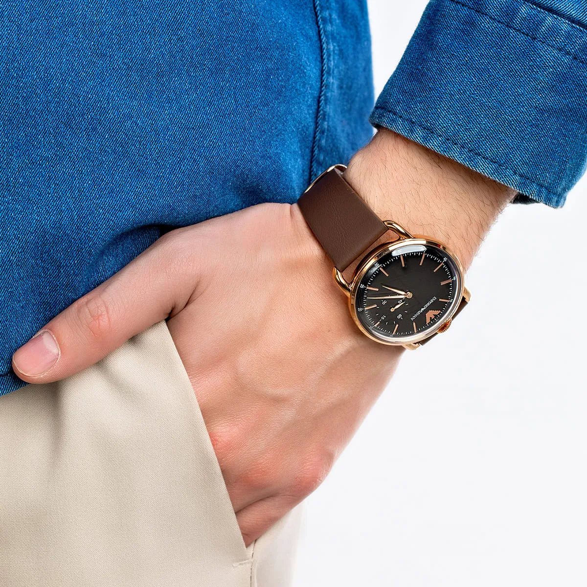 Man wearing Emporio Armani AR11337 watch with blue shirt and brown leather strap